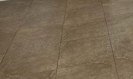 A clean tiled floor in an empty room
